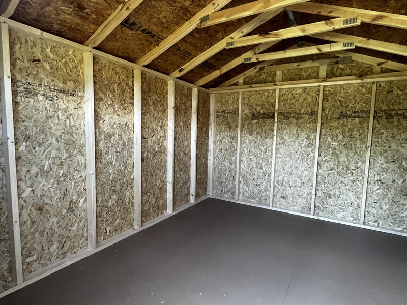 Outland Trailers 10x12 utility shed with double doors and sloped roof, ideal for storage and outdoor organization.