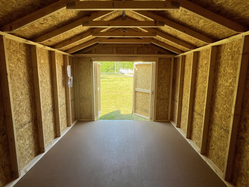 Outland Trailers 10x16 Tru-Valu utility shed shown with sturdy metal walls and a wide double door for storage access.