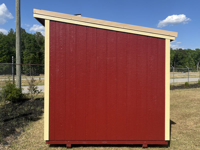 Outland Trailers 8x10 cottage shed with wooden exterior, gable roof, and double doors, ideal for storage or garden use.