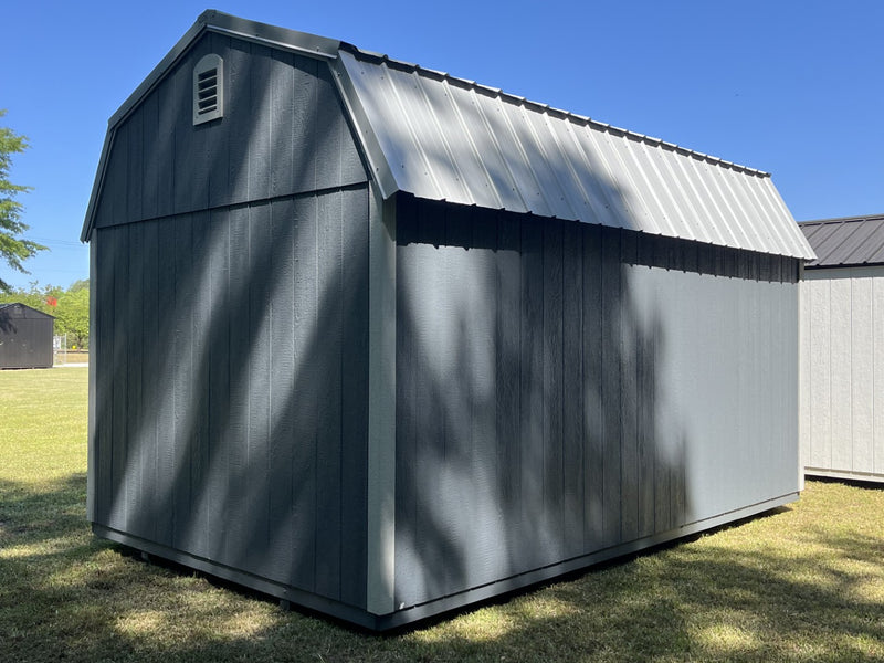 Outland Trailers 10x16 side lofted barn shed with side loft and traditional barn design, shown with wooden exterior and double doors.