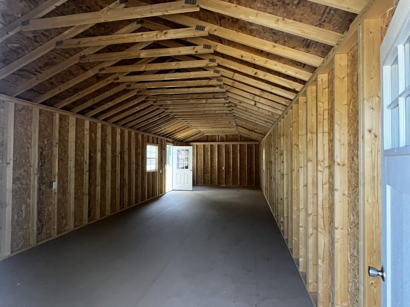 Outland Trailers 14x40 tiny home shell showing the wooden frame, exterior walls, and construction details of the tiny house.