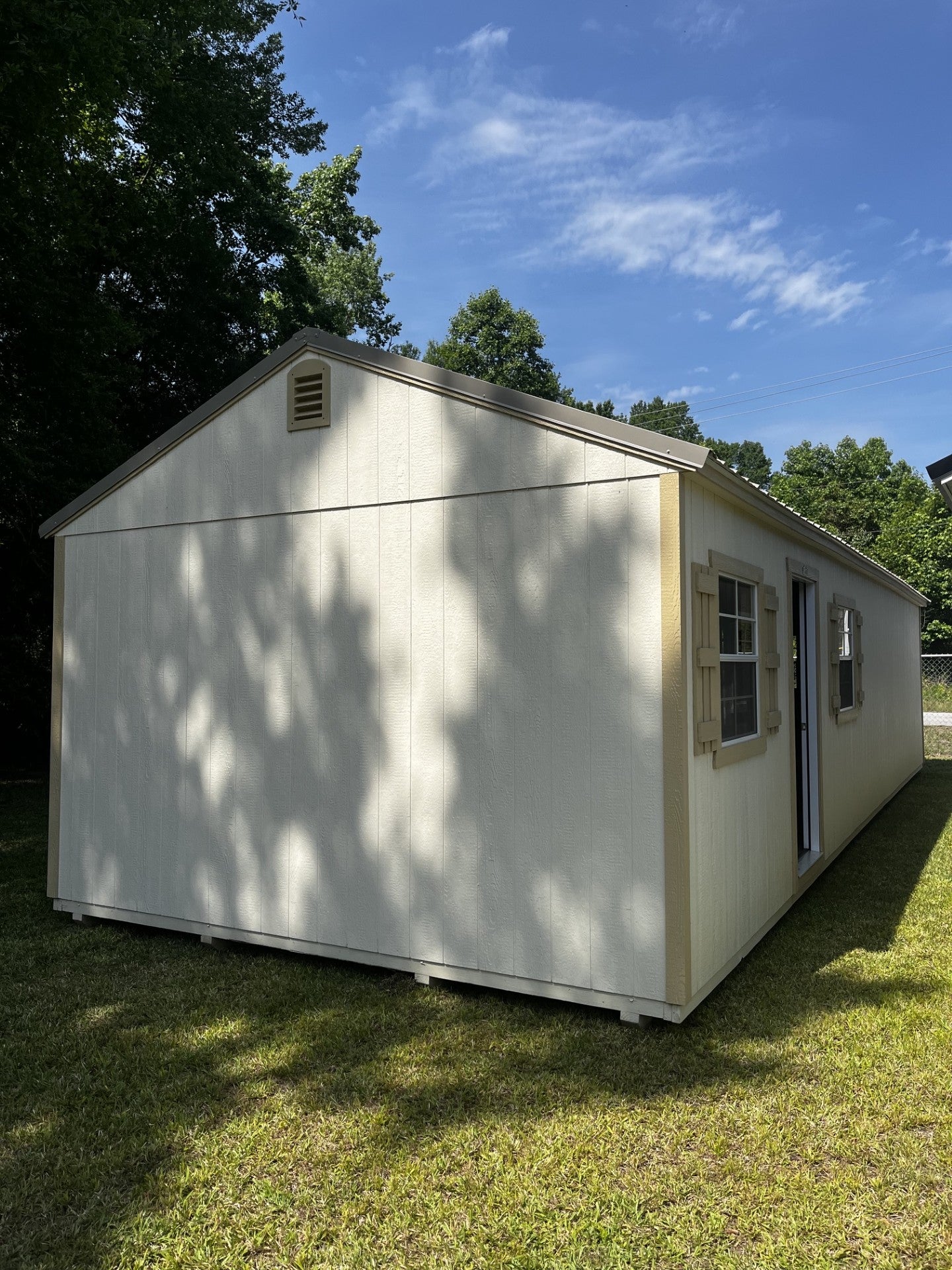 Outland Trailers 14x40 tiny home shell with wooden exterior, showcasing the compact, ready-to-finish tiny house structure.