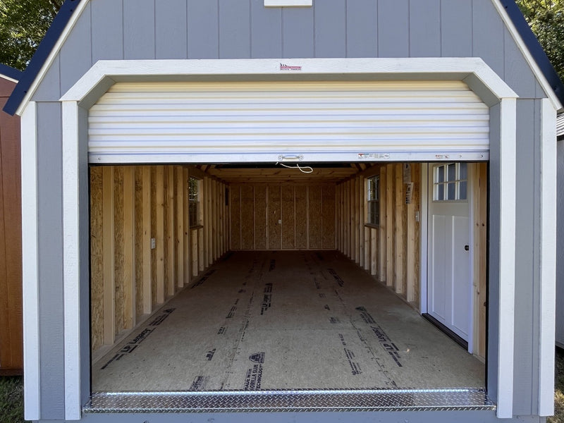 Outland Trailers 12x24 lofted garage with raised roof, side door, and window, ideal for storage and workshop space.