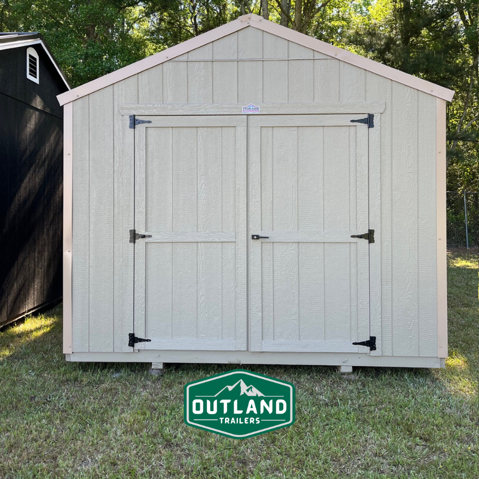 Outland Trailers 10x16 Tru-Valu Utility Shed with sturdy metal walls and a pitched roof, ideal for storage and outdoor use