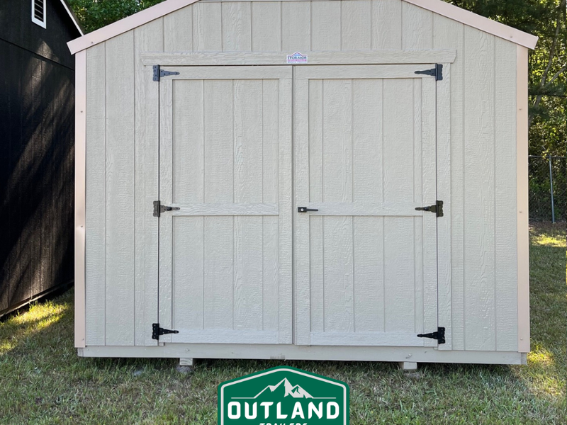 Outland Trailers 10x16 Tru-Valu Utility Shed with sturdy metal walls and a pitched roof, ideal for storage and outdoor use