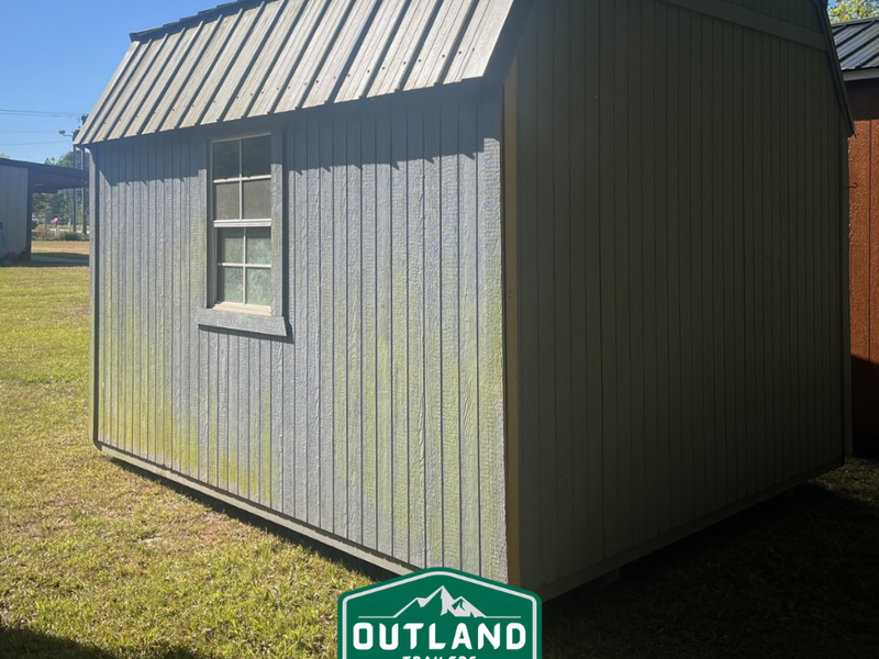 Used Outland Trailers 10x12 lofted barn with pitched roof, wooden siding, and double doors, shown in a side view.